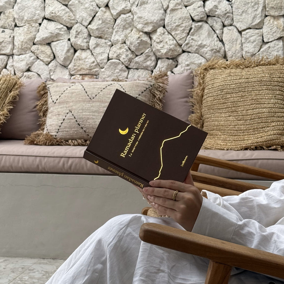 The Qalbeen Ramadan Planner resting on a chair