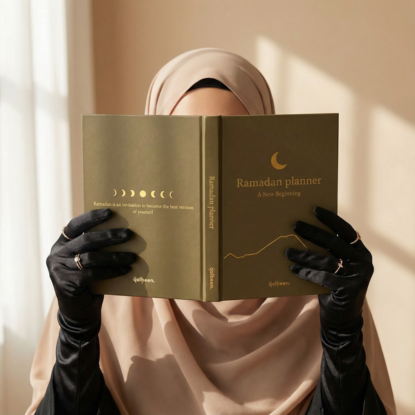A woman holding the Ramadan Planner